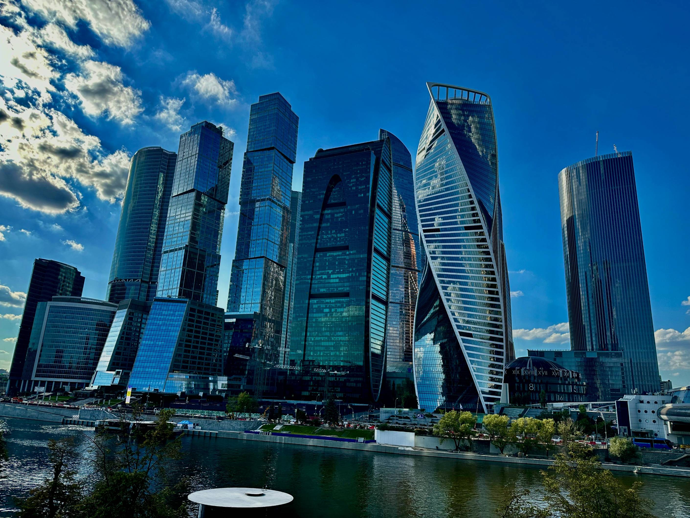 a group of tall buildings next to a body of water