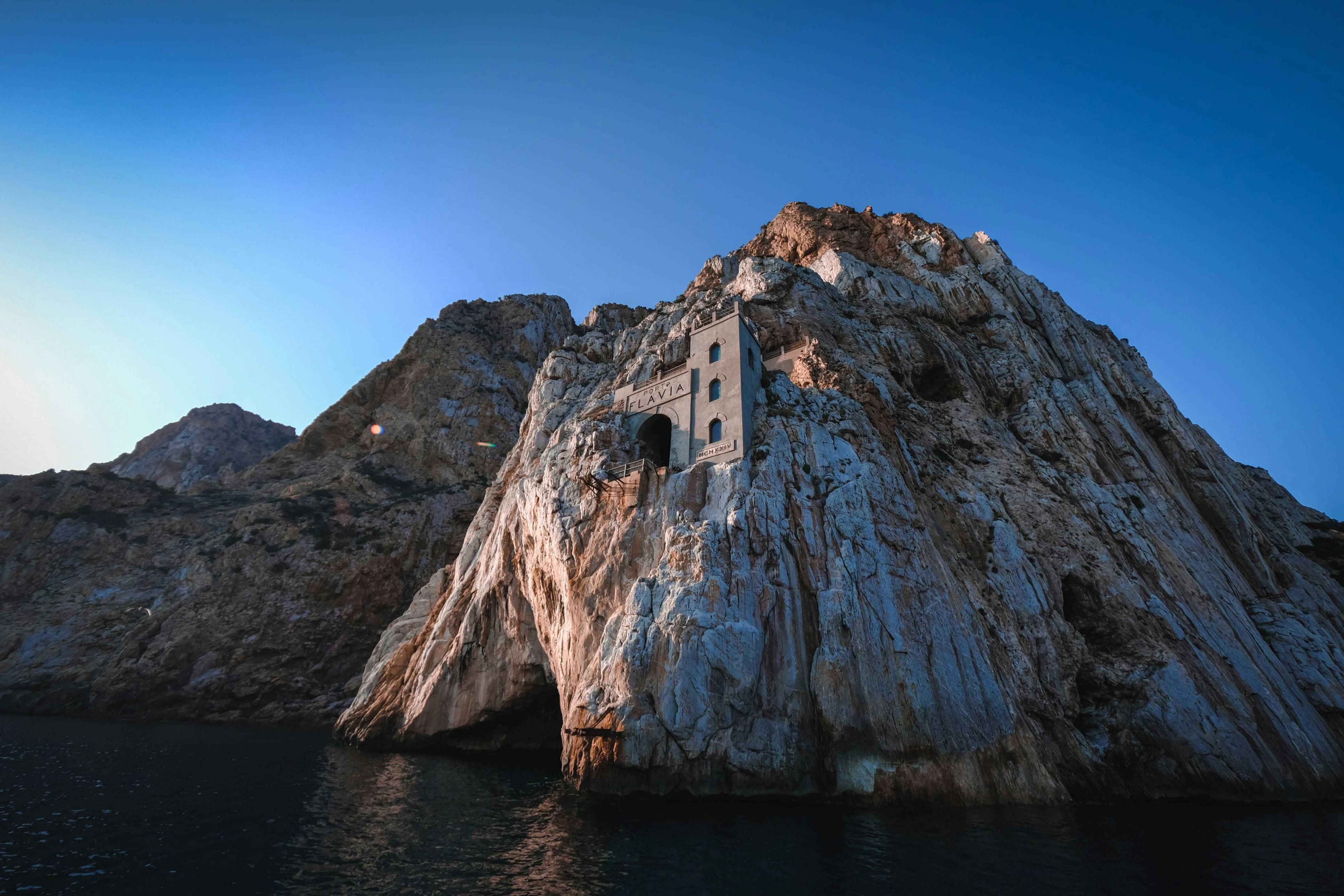a stone building on a cliff